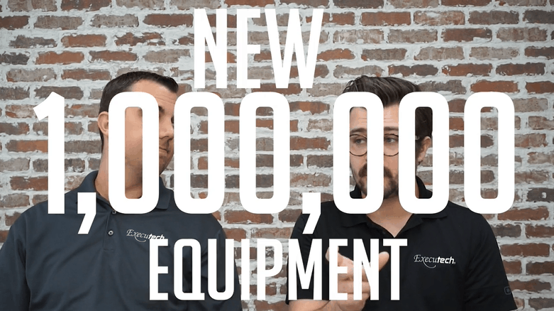 two men talking in front of a brick wall with "new 1,000,000 equipment" overlaid on the image