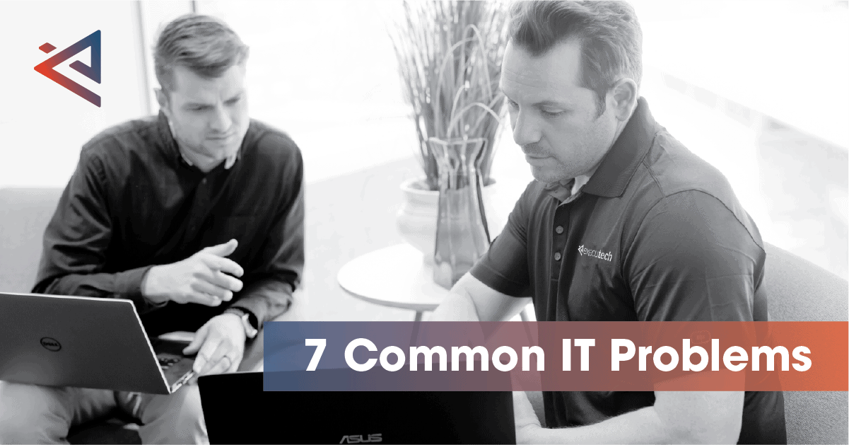 two men sitting next to each other with their laptops out