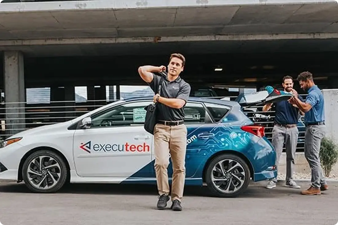 About Executech - staffer getting out of branded Car.