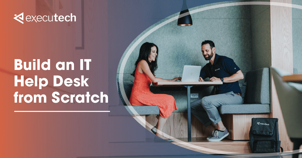 woman sitting at an office table with a man helping her on her laptop