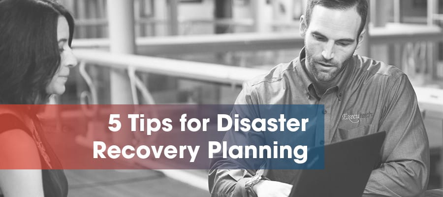 man and woman creating a disaster recovery plan on laptop