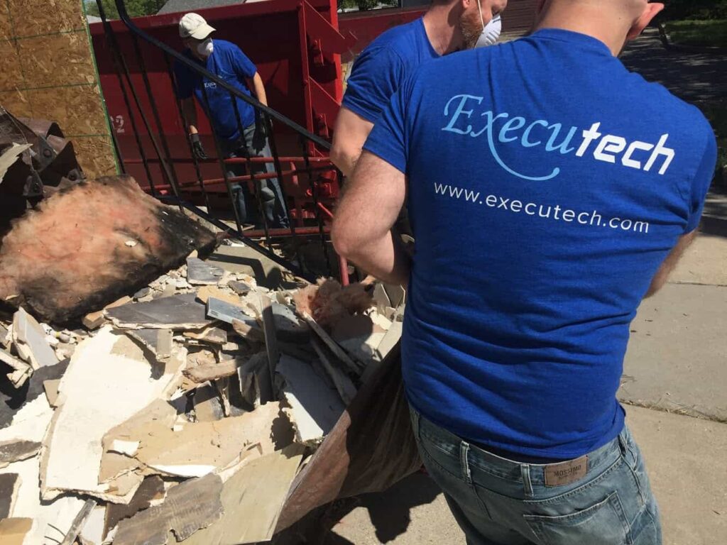 Executech leadership helping build a community center