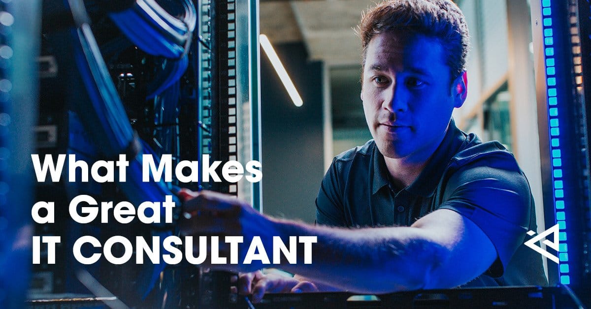 Male IT consultant working in a dimly-lit server room