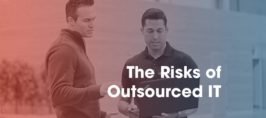 Business owner talking to IT technicians about the risks of outsourcing IT