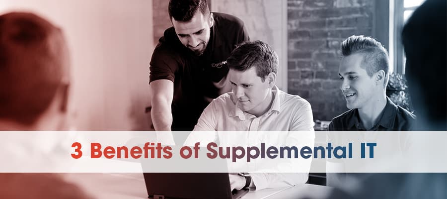 Supplemental IT technician helping employee on laptop