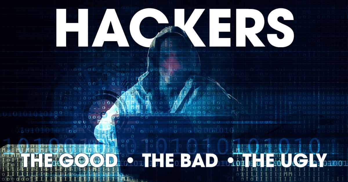 faceless, hooded figure sitting in a dark room at a desk with a laptop